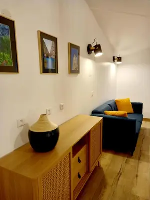 a living room with a table and a couch at Les chambres d'hôtes du Relais d'Aguilar in Tuchan