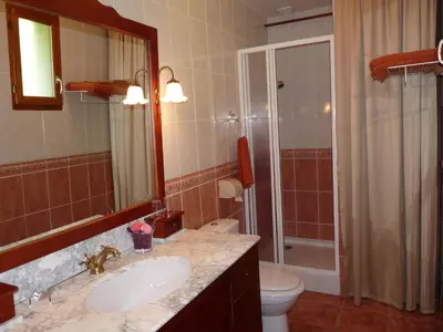 a bathroom with a sink and a toilet and a mirror at Le Moulin du Barthas in Montredon-Labessonnié