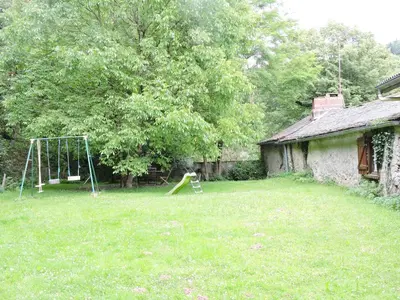 a yard with a swing set and a playground at Gîte La Maison du Meunier in Montredon-Labessonnié