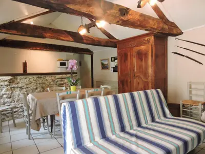 a dining room with a table and chairs at Gîte La Maison du Meunier in Montredon-Labessonnié
