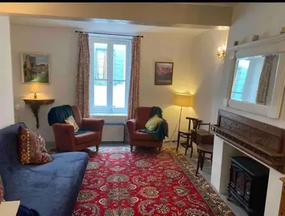 a living room with a blue couch and chairs and a fireplace at Cheerful, traditional 3 bedroom home in Quillan in Quillan