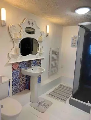 a bathroom with a toilet and a sink and a shower at Cheerful, traditional 3 bedroom home in Quillan in Quillan