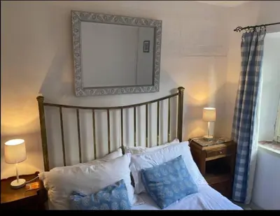 a bedroom with a bed with a mirror on the wall at Cheerful, traditional 3 bedroom home in Quillan in Quillan