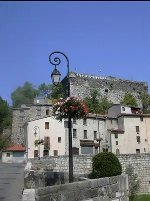 a street light with flowers on it in front of a building at Cheerful, traditional 3 bedroom home in Quillan in Quillan