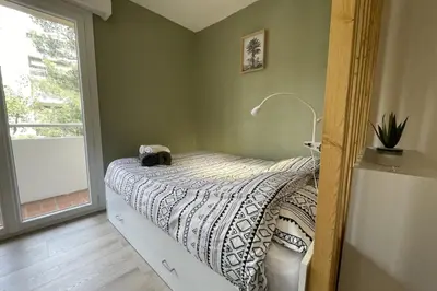 a bedroom with a bed with a cat on it at Studio Cosy - Balcon - Wifi - Free parking in Narbonne