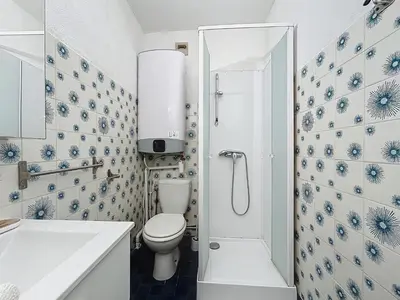 a white bathroom with a toilet and a shower at Studio Cosy - Balcon - Wifi - Free parking in Narbonne