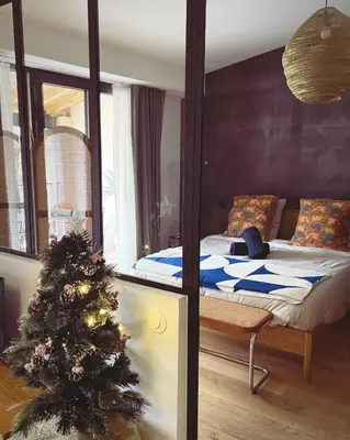 a bedroom with a christmas tree and a bed at Gîte au pied de la Cité Médiévale - Le 127 in Carcassonne