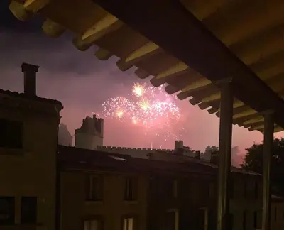 a firework display in the sky over a building at Gîte au pied de la Cité Médiévale - Le 127 in Carcassonne