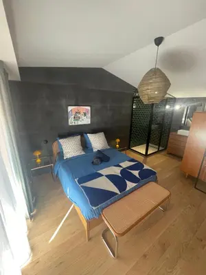 a bedroom with a blue bed in a room at Gîte au pied de la Cité Médiévale - Le 127 in Carcassonne
