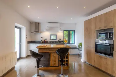a kitchen with a wooden counter top in a room at Sous les remparts la maison Pimprenelle in Carcassonne