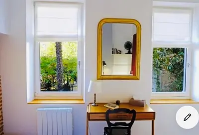 a mirror and a desk in a room with two windows at Maison centre historique Le Préau saint Jacques in Castres