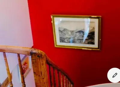 a picture on a red wall next to a staircase at Maison centre historique Le Préau saint Jacques in Castres