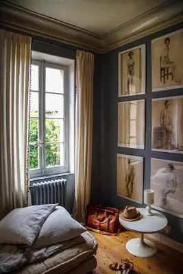 a bedroom with a bed and a table and a window at Camellas-Lloret in Montréal