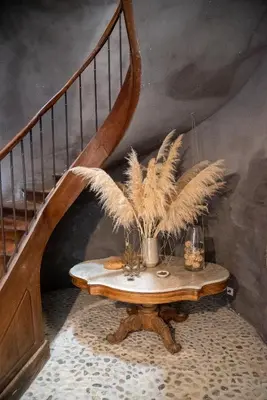 a table with feathers on it next to a staircase at Camellas-Lloret in Montréal