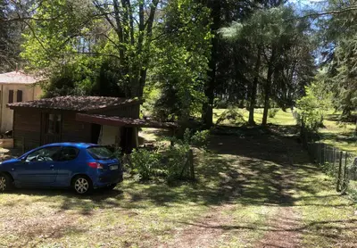 a small blue car parked in front of a house at La Cabane in Mazamet