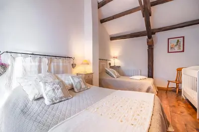 a bedroom with two beds with white sheets and pillows at Le Gîte Dame Nature in La Tourette-Cabardès