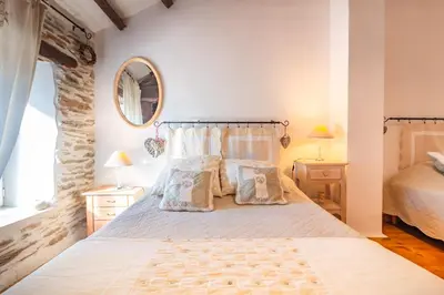 a bedroom with a bed with two pillows on it at Le Gîte Dame Nature in La Tourette-Cabardès