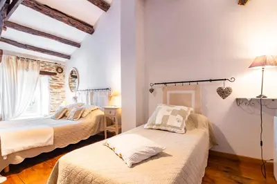 two beds in a room with white walls at Le Gîte Dame Nature in La Tourette-Cabardès