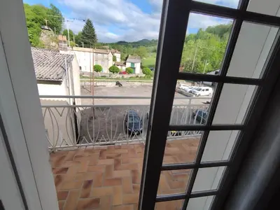 a view from an open window of a street at La Maison de Raph in Villeneuve dʼOlmes