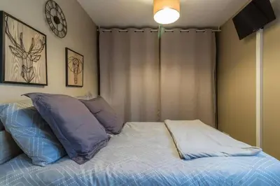 a bed with two pillows on it in a room at Gîte à la Ferme de la Bouriette in Revel
