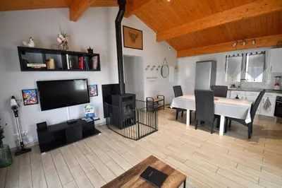 a living room with a table and a dining room at Gîte à la Ferme de la Bouriette in Revel