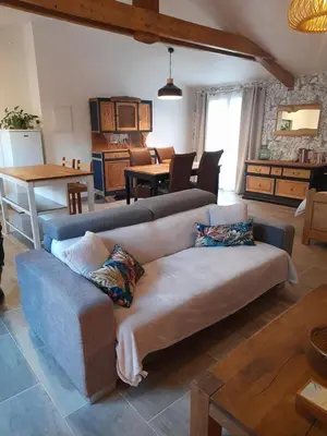 a living room with a couch and a table at L'atelier des rêves in Capestang