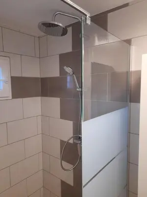 a shower with a glass door in a bathroom at L'atelier des rêves in Capestang