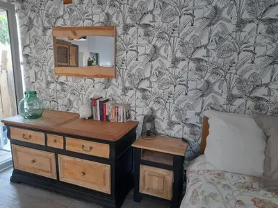 a bedroom with a bed and a dresser and a mirror at L'atelier des rêves in Capestang