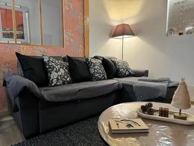 a living room with a couch and a table at L'Incarnat in Caunes-Minervois