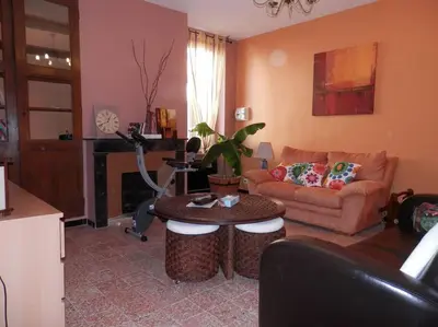 a living room with a couch and a table at Appartement spacieux avec grand patio, 1er étage in Sigean
