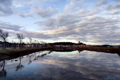 a large body of water with a cloudy sky at La Maisonnette YourHostHelper in Gruissan