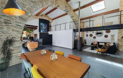 a dining room with a wooden table and chairs at Stunning Home In Pardailhan in Pardailhan