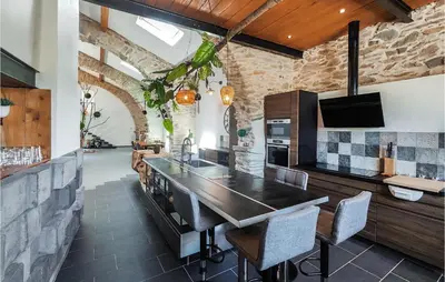 a kitchen with a table and chairs in a room at Stunning Home In Pardailhan in Pardailhan