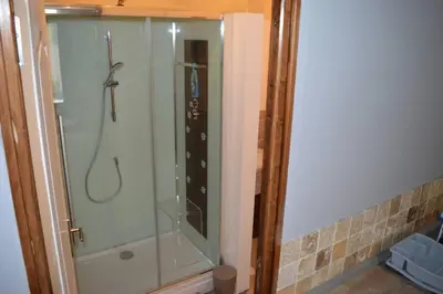 a shower in a bathroom with a glass at Spacious stone village house in Puivert in Puivert