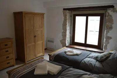 a bedroom with two beds and a window at Lovely Renovated Cottage in Puivert in Puivert