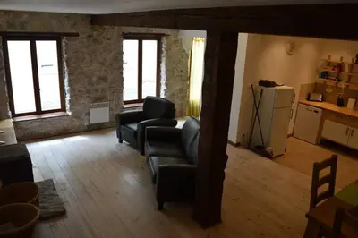 a living room with two couches and a kitchen at Lovely Renovated Cottage in Puivert in Puivert