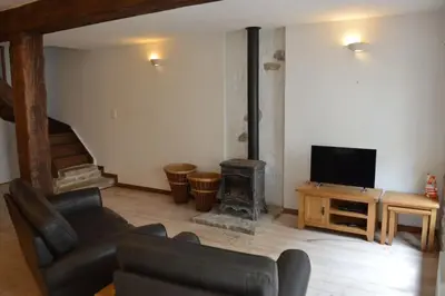 a living room with a couch and a fireplace at Lovely Renovated Cottage in Puivert in Puivert
