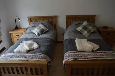 two beds sitting next to each other in a bedroom at Lovely Renovated Cottage in Puivert in Puivert