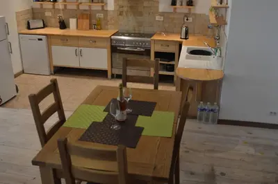 a kitchen with a wooden table with chairs and a sink at Lovely Renovated Cottage in Puivert in Puivert