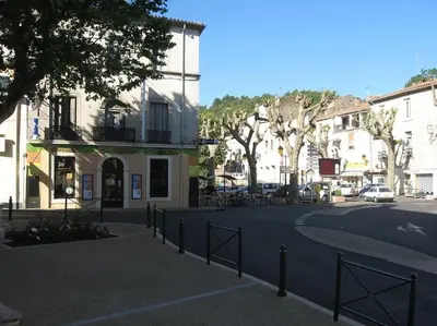 a street in a town with buildings and trees at Le Cosy Grenier de Pauline et Flo in Cessenon
