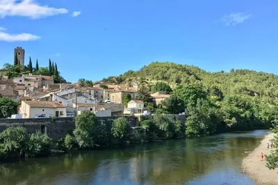a view of a river with a town in the background at Le Cosy Grenier de Pauline et Flo in Cessenon