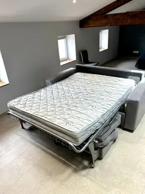 a large bed in a room with a mattress at Le Cosy Grenier de Pauline et Flo in Cessenon