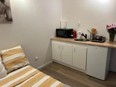 a small kitchen with a sink and a microwave at Abrilove in Castres