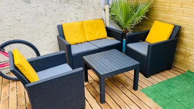 two chairs and a table on a patio at Abrilove in Castres