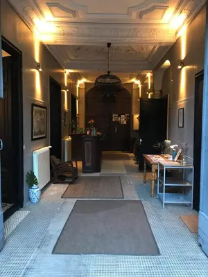 a living room with a hallway with a table and lights at Le Voyageur - Chambres d'Hôtes in Olonzac