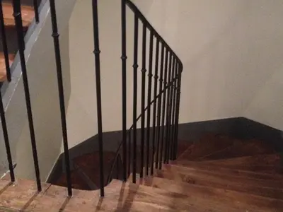 a staircase with black railings in a room at Le Voyageur - Chambres d'Hôtes in Olonzac