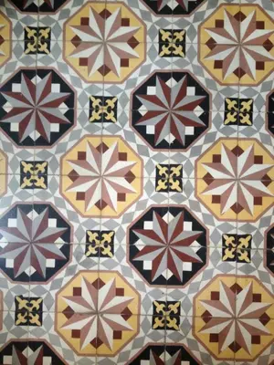 a tiled floor with many different colored tiles at Le Voyageur - Chambres d'Hôtes in Olonzac