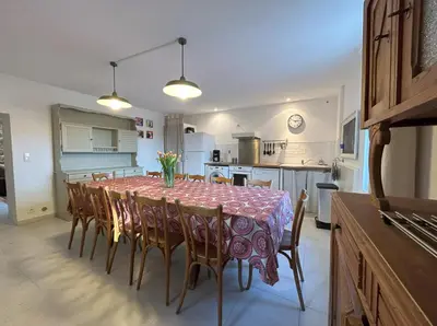 a kitchen and dining room with a table and chairs at Gîte de 12 personnes au cœur d'un domaine viticole in Gruissan