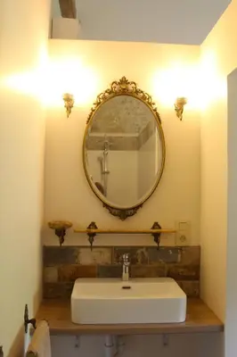 a bathroom with a sink and a mirror on the wall at Gîte - La Couderquié in Lautrec