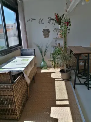 a room with a table and some potted plants at PALMA 3 in Port-la-Nouvelle